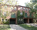 View of the back of some homes (with deeply-recessed garages) fronting on the street.