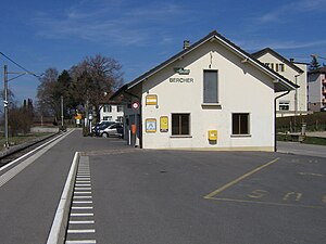 Single-story building with gabled roof on side platform