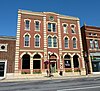 A three-story building with an ornate brick front