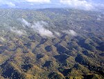 Aerial view of the Chocolate Hills, Bohol, Philippines, exhibiting both mogotes and cockpit karst characteristics.