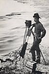 Photographer and camera along river