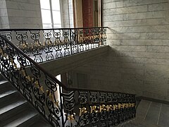 Vue de l'escalier d'honneur avec son garde-corps en fer forgé