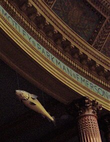 A view of the rear of the Massachusetts House of Representatives chamber, showing the Sacred Cod suspended above the railings of the visitors' gallery