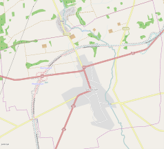 Mapa konturowa Szczuczyna, blisko centrum na dole znajduje się punkt z opisem „Parafia Imienia NMP w Szczuczynie”