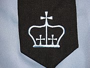 The crown embroidered on the university's academic regalia