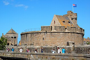 Depuis les remparts de la ville, vue sur tour Quic-en-Groigne (à gauche) et la tour Générale, avec en arrière-plan les tours de guet du Grand Donjon sur lequel flotte le drapeau de la ville.