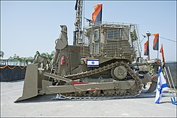 D9R עם מיגון דור 3.5 הכולל מיגון כלוב ("מיגון סטטיסטי") ומיגון בוכנות משופר. שימו לב לפנסים הממוגנים מעל הבוכנות ולמקלע מאג חש"ן שעל גג תא המפעיל.