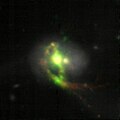 VLT MUSE image of Mrk 463, with H-alpha being orange and oxygen being green.