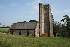 Stone building with square tower.