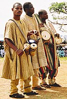 Yoruba Nigerian men of Kwara origin, wearing traditional clothing and playing drums