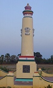 A pillared memorial within a small walled enclosure