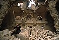 Vedran Smailović tocando el violonchelo en las ruinas de la Biblioteca Nacional de Sarajevo, destruida por la guerra de Bosnia en 1992. Por User:Evstafiev