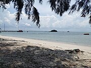 White sandy beach in Besar Island near the jetty, overlooking Lalang Island.