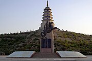 Monument to the return of the Torghut in Korla, Xinjiang. Statue of Ubashi Khan in the front and the memorial tower in the back.