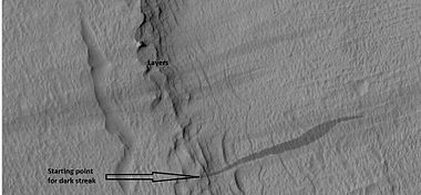 Close-up of some layers under cap rock of a pedestal crater and a dark slope streak, as seen by HiRISE under HiWish program