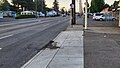 Image 26A patched road rut at a Portland Oregon bus stop. During the summer this part of the road will be hot and combined with a bus’s high ground pressure will compress and deform part of the road. Due to the lower elevation from the driveway, a large portion of the buses weight leans on one wheel causing damage to the road. Despite the repairs, you can see the patch is already damaged. This is all happens yearly. (from Road surface)