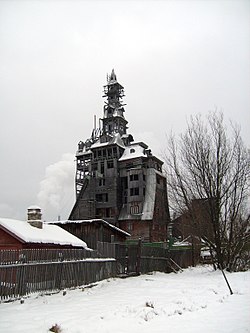 Tall wooden, run down, building, seen from the distance