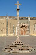 Cruzeiro (a Stone cross) and façade of the Monastery of Jesus of Setúbal.