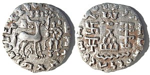 Silver coin of the Kuninda kingdom, c. 1st century BCE. These coins followed the Indo-Greek module.[1] Obv: Deer standing right, crowned by two cobras, attended by Lakshmi holding a lotus flower. Legend in Prakrit (Brahmi script, from left to right): Rajnah Kunindasya Amoghabhutisya maharajasya ("Great King Amoghabhuti, of the Kunindas"). Rev: Stupa surmounted by the Buddhist symbol triratna, and surrounded by a swastika, a "Y" symbol, and a tree in railing. Legend in Kharoshti script, from right to left: Rana Kunidasa Amoghabhutisa Maharajasa, ("Great King Amoghabhuti, of the Kunindas"). of Kingdom of Kuninda