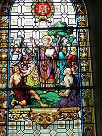 Stained glass window of Saint-Mathurin converting idolaters, including his father and mother.