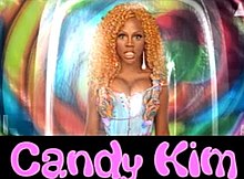 An image of a dark-skinned woman wearing a blonde/orange wig with the words "Candy Kim" in a pink font at the bottom of the screen