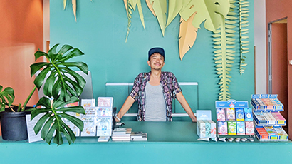 Retail business owner standing infront of colourful counter