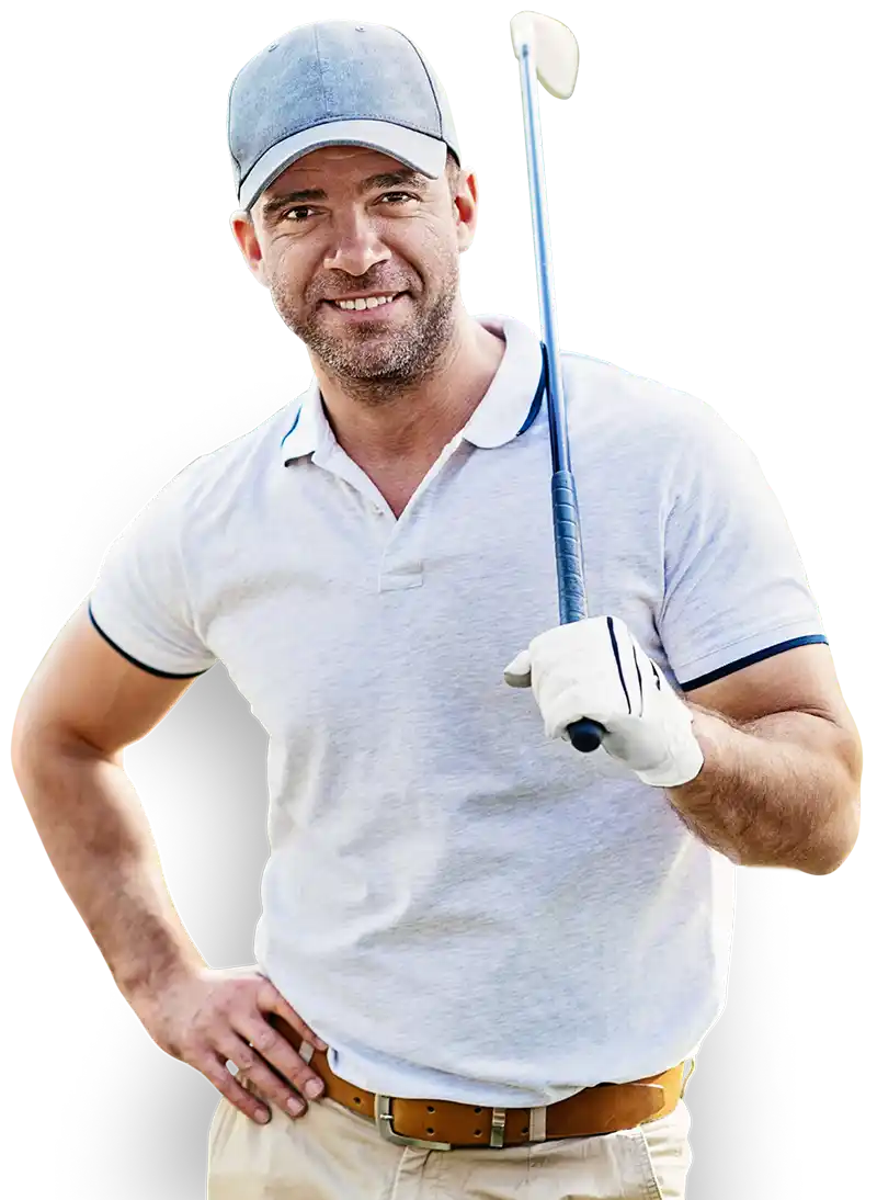 Golf course operator in a blue baseball cap and white polo shirt poses with his right hand on his hip, and his golf club held over his left shoulder.