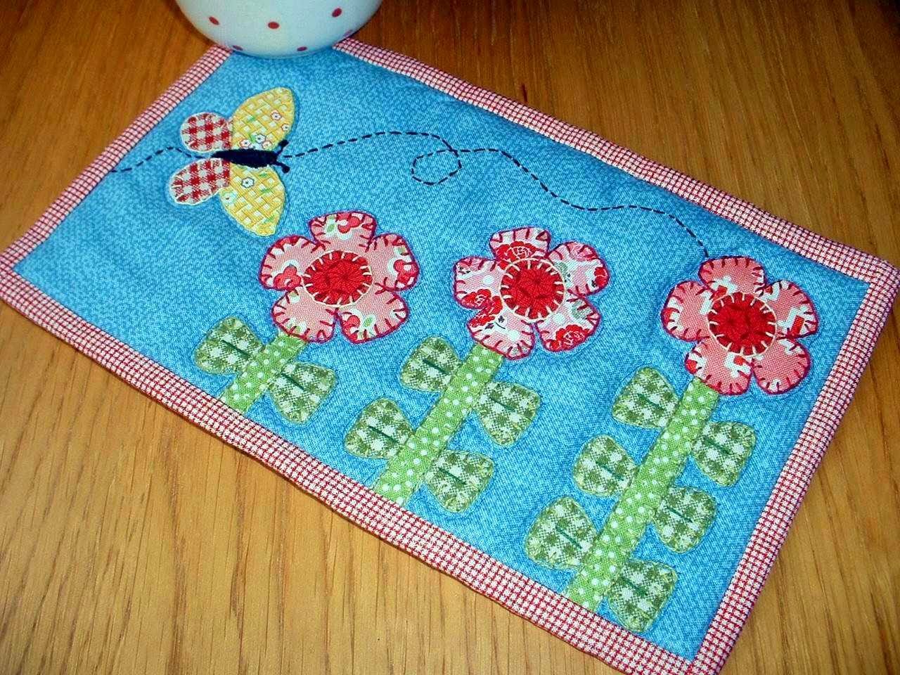 http://www.craftsy.com/pattern/quilting/home-decor/growing-flowers-mug-rug/47635