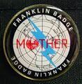 A photograph of the Franklin Badge packaged with the Mother 3 deluxe box.