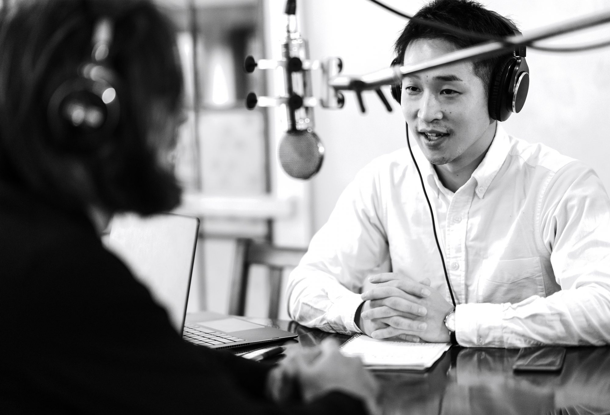 Man conducts a radio interview in a sutdio.