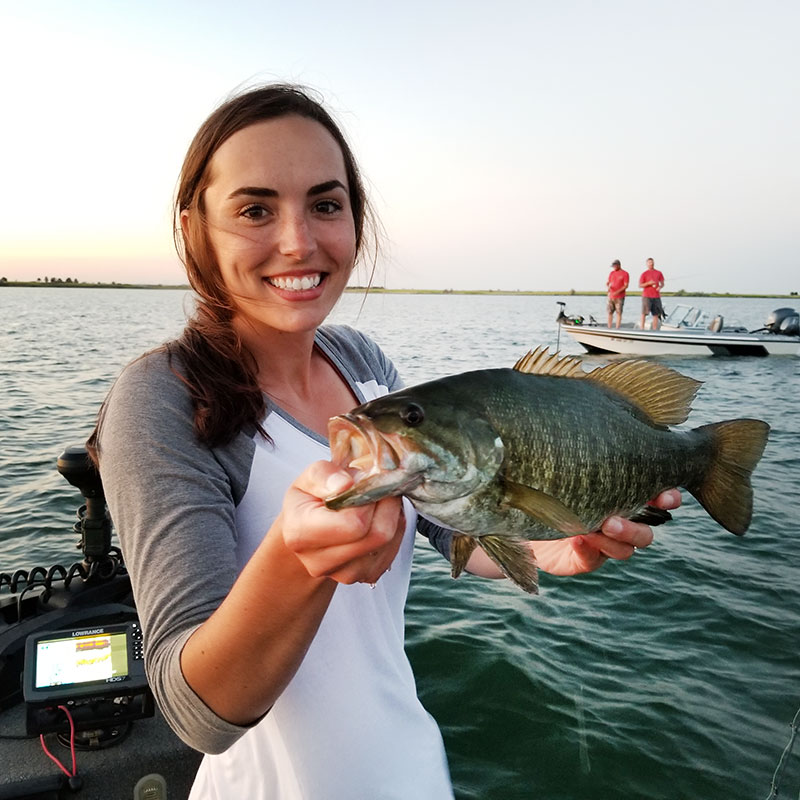 Angler on boat holding fish