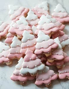 some pink and white decorated cookies on a table