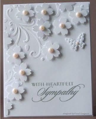 a greeting card with white flowers and pearls on the front that says, with heart felt sympathy