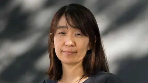 Han Kang pictured with a grey background