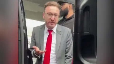 Airport employee dressed in suit