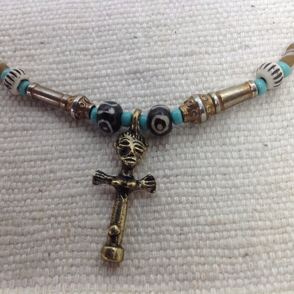 Necklace with an African brass charm and prayer beads from Tibet 