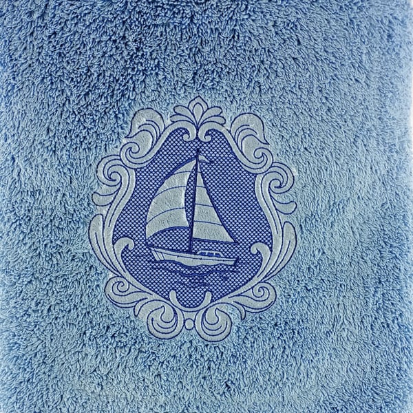 Sailing ship embossed in blue embroidery thread on a blue hand towel