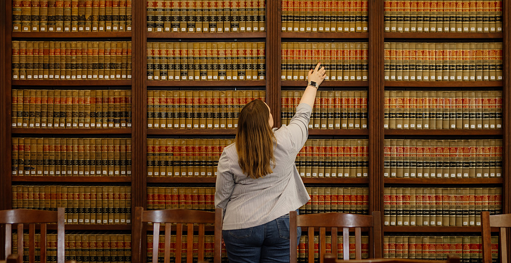 Student looking for specific book at Taggart Law Library