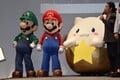 Tamadra, Luigi, and Mario at the Puzzle & Dragons: Super Mario Bros. Edition conference