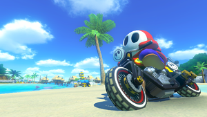 Shy Guy driving through DS Cheep Cheep Beach in Mario Kart 8