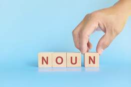 wooden block letters spelling the word noun