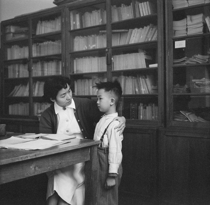 A nurse in Hong Kong - Betty Alt started to help the government in its maternal and child health programme in 1954. Although there is still much to be done to improve the health of the mothers and children in Hong Kong, the Government has made great strides in organizing a maternal and child health programme.  The School Nurse talks to a sick child who is about to be sent home.