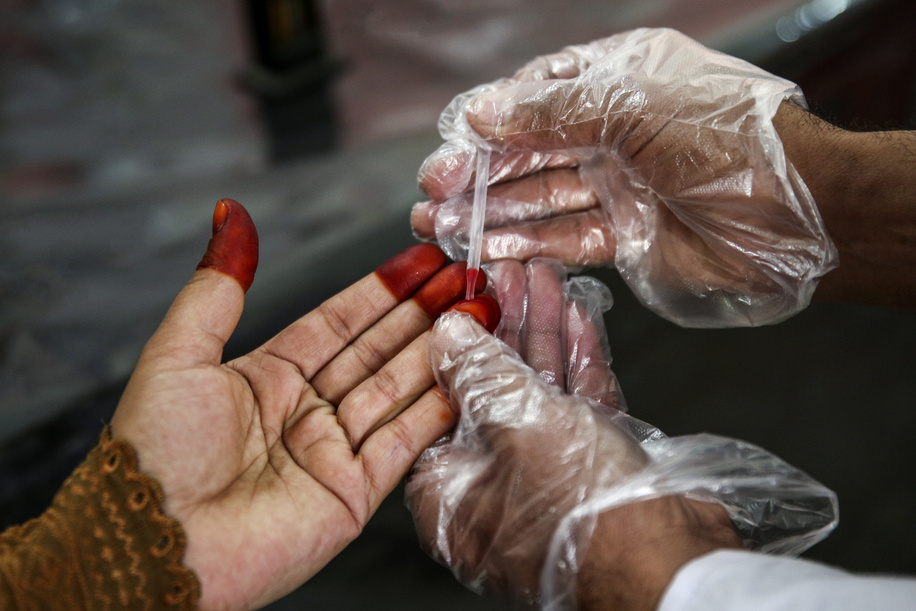 Health facilities in Pakistan Lal Mohammad, collecting blood of a pregnant woman to conduct a hemoglobin test in a Basic Health Unit (BHU) Akora II, Nowshera District.