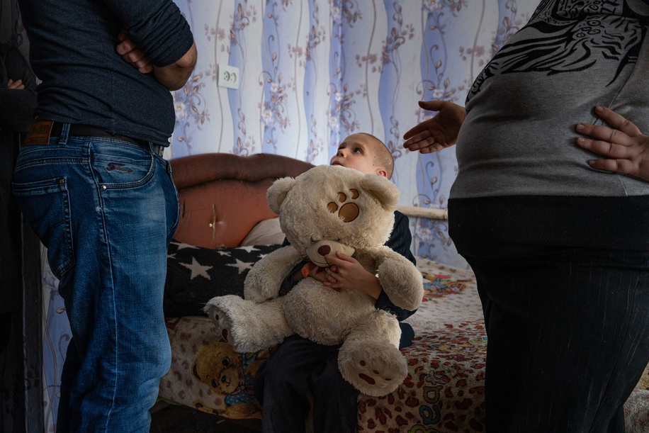 Psychiatrist Oleksii K., left, a member of the WHO-supported mobile mental health team, visits former patient Nataliia, 39, right, at her home on 15 February 2021 in Bylbasivka, Ukraine. Nataliia's son Kyryl, 8, sits in between listening to the conversation with a teddy bear. The COVID-19 pandemic and protracted conflict along the Ukraine-Russian border have had a devastating impact on Ukrainians with severe mental health conditions. These coinciding events have further limited their access to specialized care. Introduced by WHO in 2015, the community mental health teams project originally aimed to provide comprehensive community-based mental health care to people who faced consequences of the conflict. In 2020 WHO has reinforced its support to Ukraine in the area of mental health as a part of WHO Special Initiative for Mental Health, and seven community mental health teams are working across Ukraine during the COVID-19 pandemic. Community-based care is a new approach for mental health care in Ukraine but with the support from WHO, Ukraine aims to scale up the teams for people with severe mental health conditions throughout the country. A team based in Slovyansk and consisting of a psychiatrist, a psychologist, a nurse and a social worker travel to different settlements in the region to deliver specialized mental health care to their patients. The team helps the person to develop their recovery plan, cope with symptoms of mental health conditions and prevent crisis, supports them in maintaining activities of daily living and social relations, engages resources available in community for education, housing, employment and social protection.