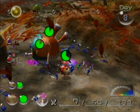 Blue Pikmin are battling a Gatling Groink in the Wistful Wild