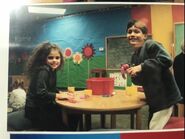 Selena Gomez and with Zachary Fountain in the set classroom playing with Play-Doh.