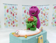 Baby Bop splashes in the bath.