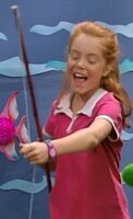 Beth playing the fishing game in "It's Your Birthday, Barney!".