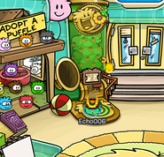 A gold puffle eating a gold O'berry