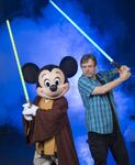 Mark Hamill with Mickey Mouse holding lightsabers at Disney's Hollywood Studios in June 2014.